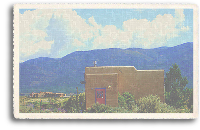 A modern-day basic adobe structure outside Taos, New Mexico. Taos Mountain and plenty of clear, blue sky can be seen in the background, offering a glimpse into the kind of scenery Northern New Mexico residents typical enjoy.